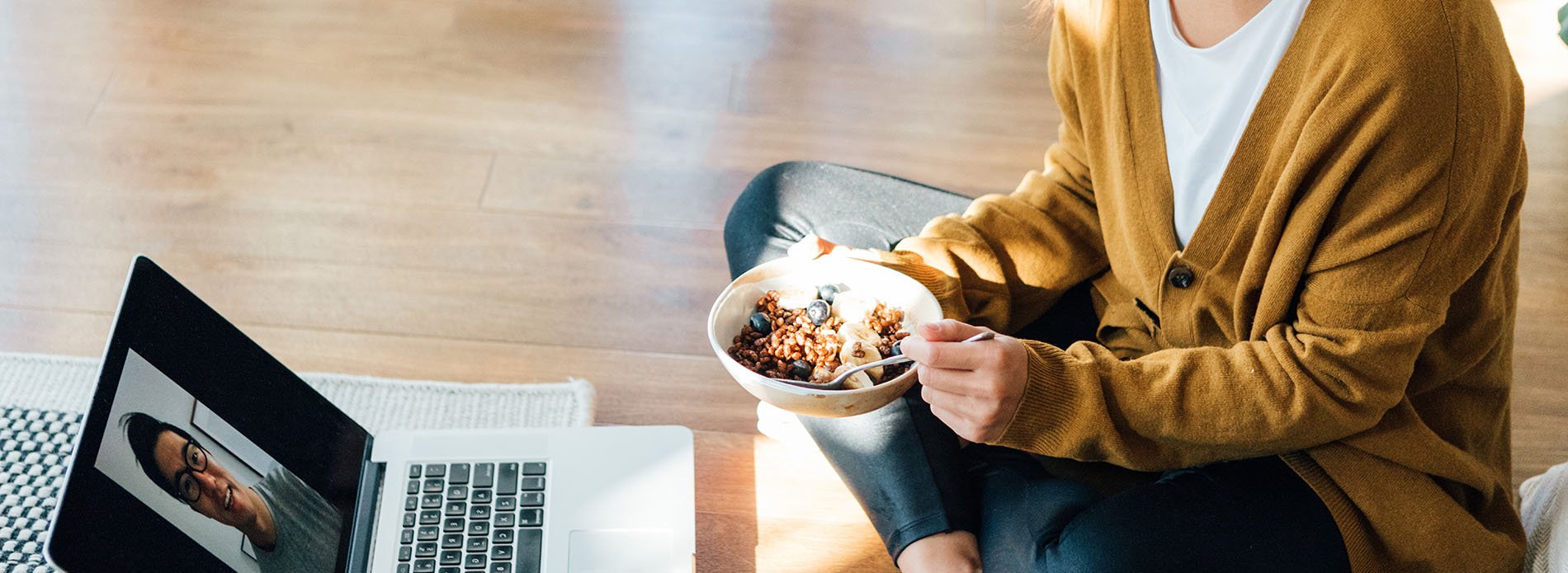 Woman eating cereal while in a Teams meeting