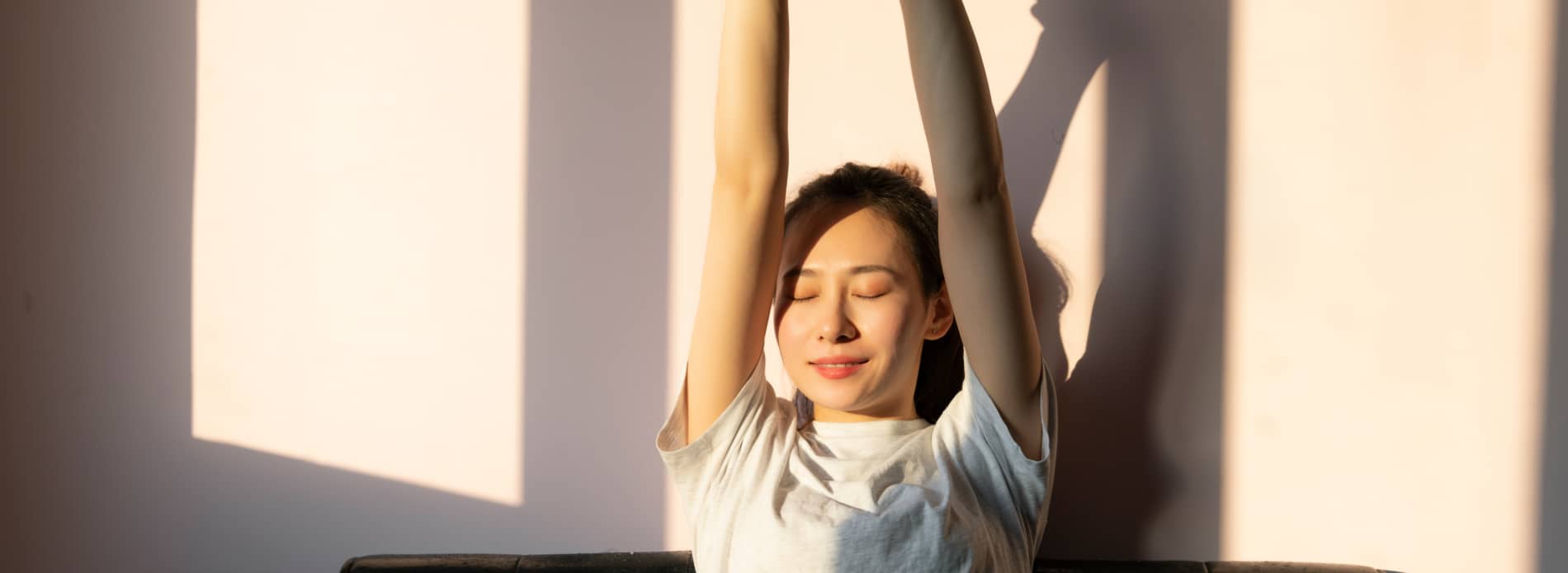 Lady stretching with arms up