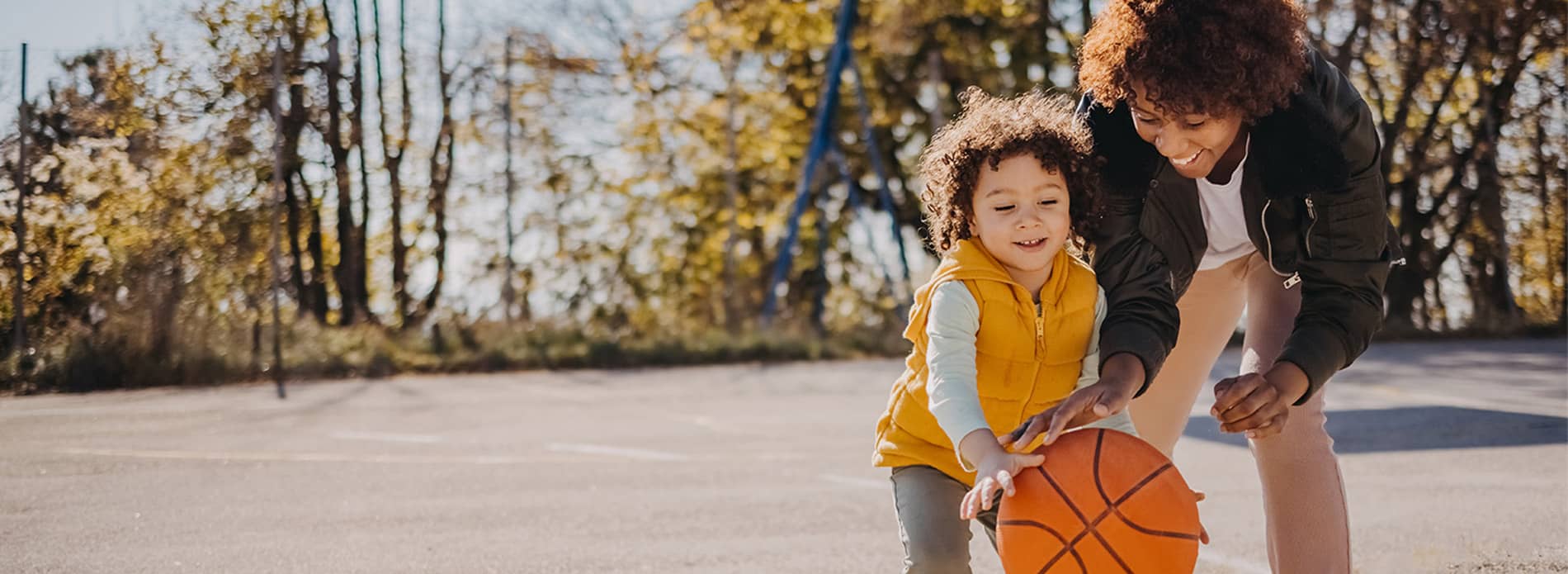 Mum and son playing basketball